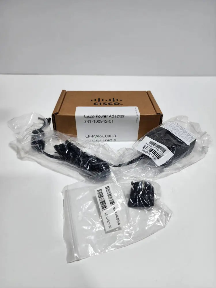 Cisco power adapter CP-PWR-CUBE-3 with cable and plug in packaging, brown box on white background