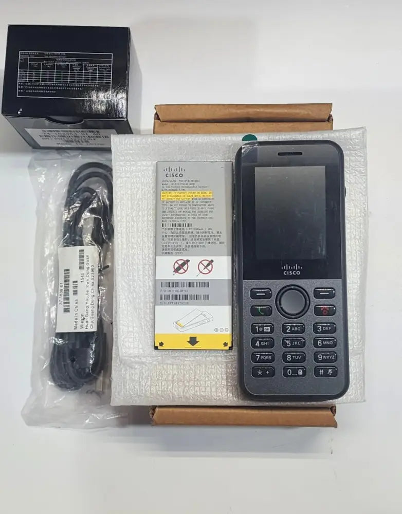 Cisco 8821 wireless IP phone bundle with handset, battery, charger, and accessories on table