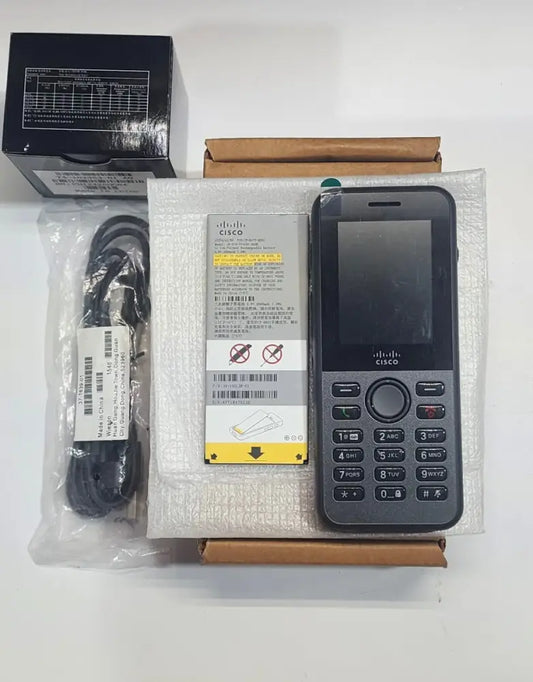 Cisco 8821 wireless IP phone bundle with handset, battery, charger, and accessories on table