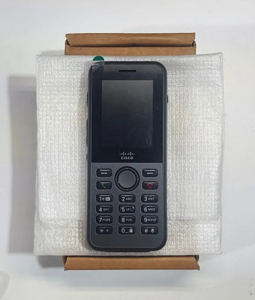 Cisco 8821 wireless IP phone refurbished, placed on white packaging and a cardboard box